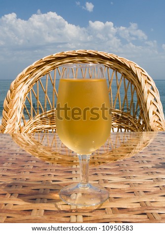 Glass with cold beer on a little table of cafe