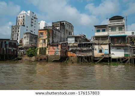 CAN THO, VIETNAM - JANUARY 26 : Run down houses on the bank of Mekong river on January 26, 2014 in Can Tho, Vietnam.