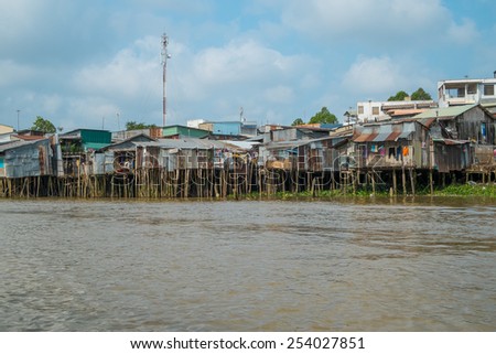 CAN THO, VIETNAM - JANUARY 26: Run down houses on the bank of Mekong river on January 26, 2014 in Can Tho, Vietnam.
