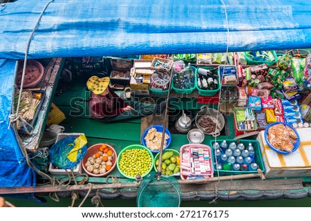 HA LONG BAY, VIETNAM - JANUARY 29, 2014: A Vietnamese woman selling goods from her boat at Ha Long Bay in January 2014.