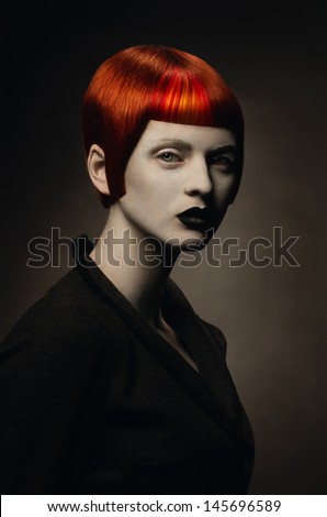 Dark portrait of pale gothic woman with creative hairstyle