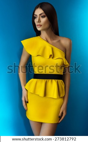 Woman in yellow dress on blue background