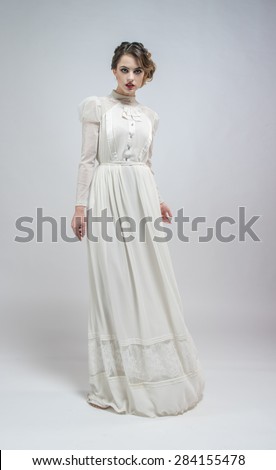 Sexy woman in white long retro dress