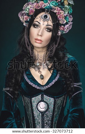 Beautiful fantasy elf woman in floral crown and medieval dress