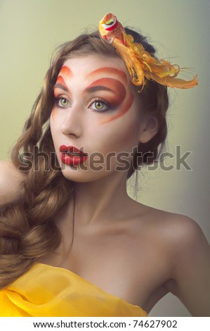 Studio beauty portrait with yellow bird. Art concept