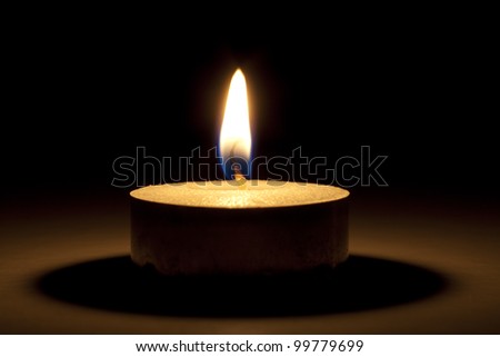 single candle in dark