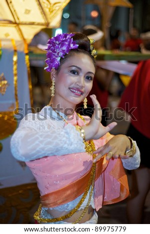 CHIANG MAI, THAILAND - NOVEMBER 9:  Thai lady dances in colorful costume at the opening parade of the Loy Krathong Festival in Chiang Mai, Thailand on November 9, 2011