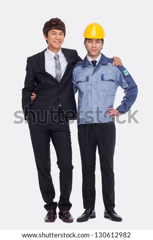 Asian Business man and engineer put arms around each other\'s shoulders.