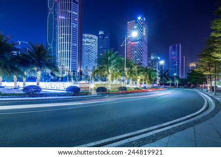 curved light trails on the city road in guangzhou central business district with modern buildings at night