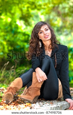 Fashion shoot of modern young woman in autumn forest,park or woods