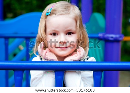 Portrait of a 3 year old girl in playground equipment