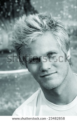Black and white photo of good looking blond surfer guy.