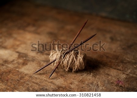 Rustic looking knitting needles in textured yarn