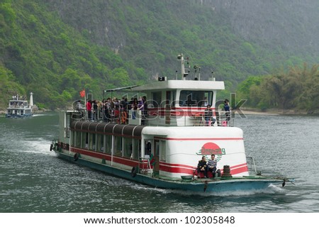 GUILIN, CHINA - APRIL 11 :  A cruise boat down the Li River in Guilin, April 11, 2011. A trip on a cruise boat down the Li River to Yangshuo is a popular activity in Guilin