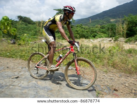 LANGKAWI, MALAYSIA - OCTOBER 18: An unidentified athlete participates in the Langkawi International Mountain Bike Challenge on October 18, 2011 in Langkawi, Malaysia. It is a 5-day stage race, from Oct. 18-22, 2011.