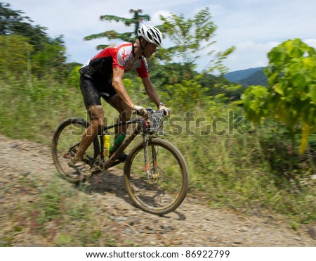 LANGKAWI, MALAYSIA - OCTOBER 18:An unidentified athlete participates in the Langkawi International Mountain Bike Challenge on Oct.18, 2011 in Langkawi,Malaysia. It is a 5-day stage race, from Oct.18-22,2011