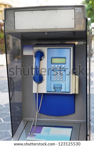 Traditional old style pay phone at street