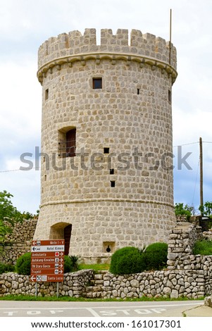 CRES, CROATIA - MAY 17: Cres castle tower on MAY 17, 2010. Medieval castle tower at sunny day in Cres island, Croatia.