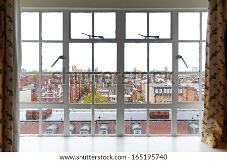 View trough window over South Kensington roofs in London