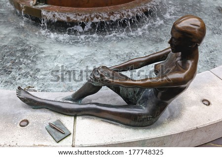 LONDON, UNITED KINGDOM - JANUARY 25: Female bronze statue on JANUARY 25, 2013. Waterfall fountain with statue by the sculptor Antony Donaldson in Horselydown Square in London, United Kingdom.