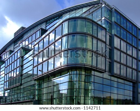 Public building on the corner of the streets in London with glass walls