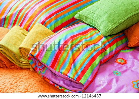 Colorful bedding pillows and blankets with straps