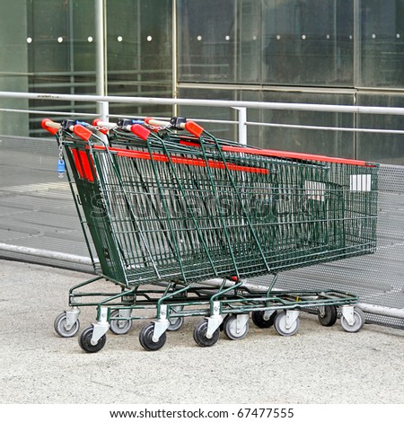 Several empty shopping carts at supermarket parking