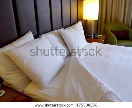 turned down bed in hotel room