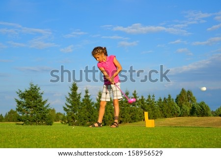 Golf, girl golfer hitting the ball