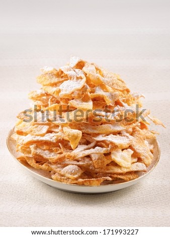 Angel wings, are a sweet crisp pastry made out of dough that has been shaped into thin twisted ribbons, deep-fried and sprinkled with powdered sugar to celebrate Fat Thursday or Mardi Gras