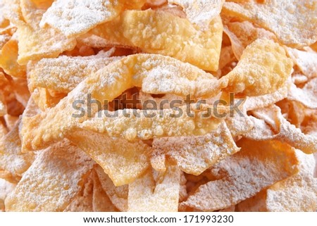 Angel wings, are a sweet crisp pastry made out of dough that has been shaped into thin twisted ribbons, deep-fried and sprinkled with powdered sugar to celebrate Fat Thursday or Mardi Gras