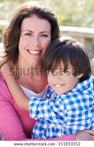 Portrait Of Mother And Son Hugging Outdoors