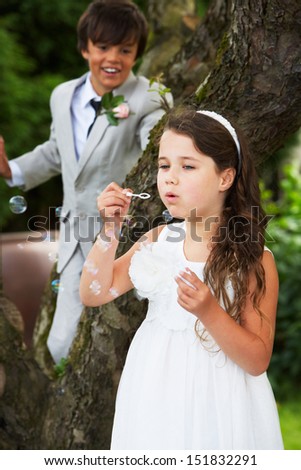 Similar – Foto Bild Ringträger bei Gartenhochzeit spielt mit Blumenstrauß