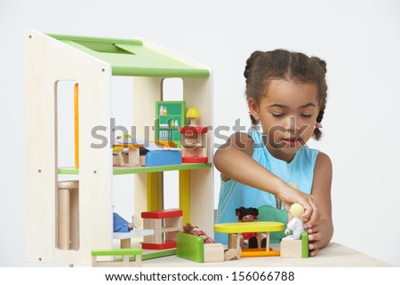 Pre-School Pupil Playing With Wooden House