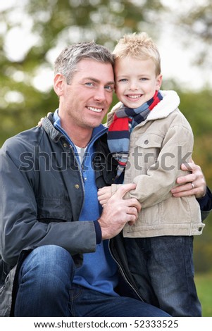 Father And Son Hugging On Outdoor Autumn Walk