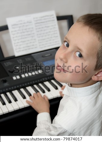 Happy little boy playing electric piano, keyboard. Educational illustration of music lessons.