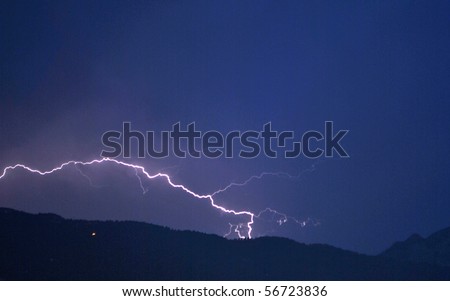 lightning in the night sky background of the Dolomites mountains