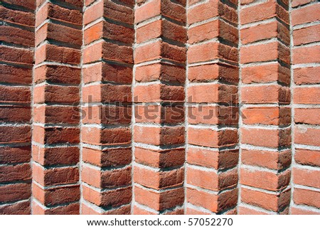 red brick wall with joints in concrete and natural materials and low environmental impact