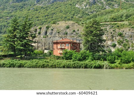 cottage with a river surrounded by nature
