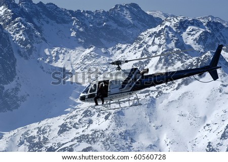 helicopter flight over the snow-capped Dolomites and blue sky