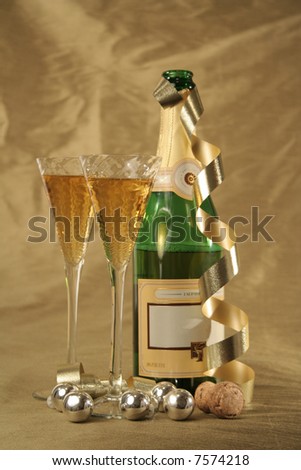 Champagne bottle and glasses isolated on gold background