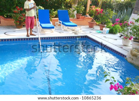 man cleaning pool with lots of flowers