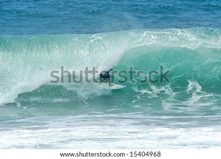 surfer getting tubed in a perfect wave