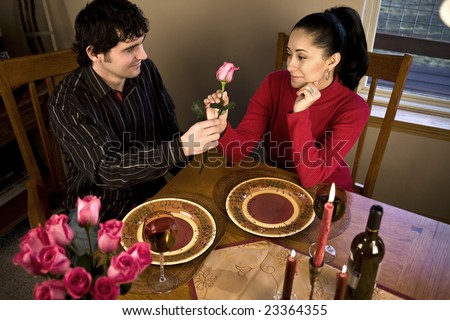 A young couple having a romantic candle light dinner