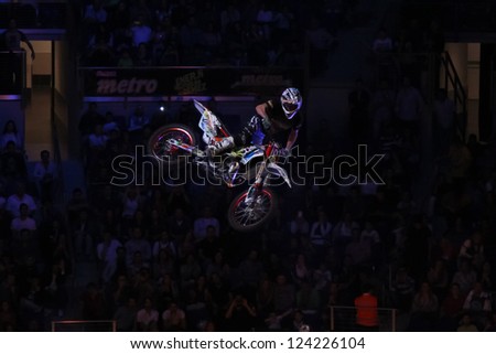 ISTANBUL - OCTOBER 13: Unidentified driver jumping during Ulker Metro Moto Heroes FMX Freestyle Motocross Motorcycle Stunt Show in Ulker Sports Arena on October 13, 2012 in Istanbul, Turkey.