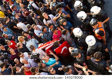 ISTANBUL - JULY 06: Police forces block Istiklal Street and dont let anyone to pass on July 06, 2013 in Istanbul, Turkey. People are protesting the prohibition of entry to Gezi Park since 15 June 2013