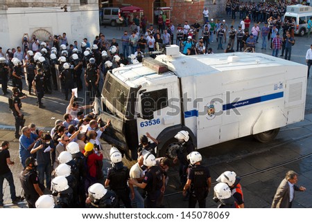 ISTANBUL - JULY 06: Taksim Solidarity and Gursel Tekin try to stop Riot Control Vehicle on July 06, 2013 in Istanbul, Turkey. People are protesting the prohibition of entry to Gezi Park