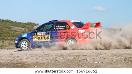 ISTANBUL - SEPTEMBER 28: Umit Can Ozdemir drives Mitsubishi Lancer Evo 9 of Team 47 Motorsports in 42nd Bosphorus Rally Kadilli Stage on September 28, 2013 in Istanbul, Turkey.
