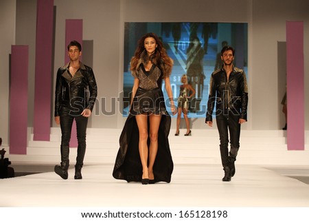 ISTANBUL - NOVEMBER 23: Ozge Ulusoy walks on the Studio Vogue Leather catwalk during 8th Istanbul Leather Fair runway on November 23, 2013 Istanbul, Turkey.