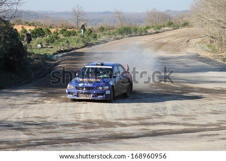 ISTANBUL - DECEMBER 15: Umit Can Ozdemir drives Mitsubishi Lancer Evo 9 of Team 47 Motorsports in 34th Opar Olio Istanbul Rally, Ulupelit Stage on December 15, 2013 in Istanbul, Turkey.
